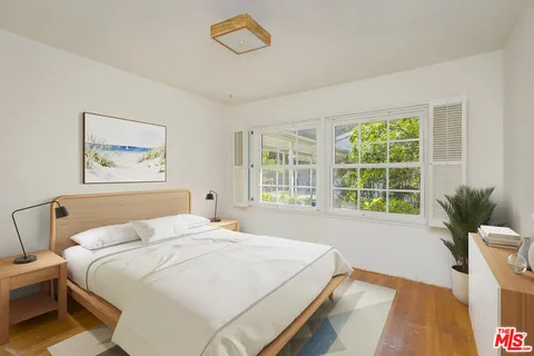 a spacious bedroom with a large bed and a large window