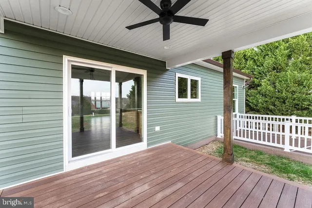 a view of backyard with deck and outdoor space