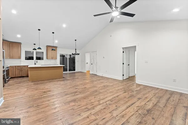 a view of a kitchen with a sink and a refrigerator