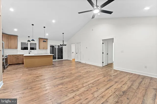 a view of a kitchen with a sink and a refrigerator