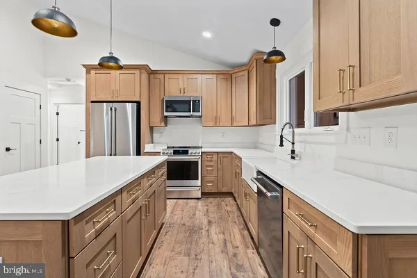 a kitchen with refrigerator cabinets and a sink