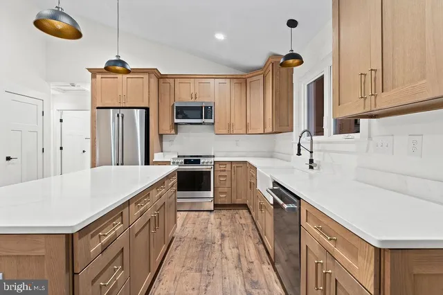 a kitchen with refrigerator cabinets and a sink