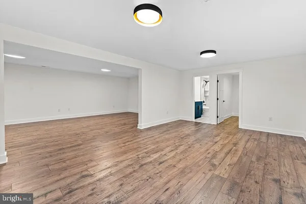 a view of empty room with wooden floor