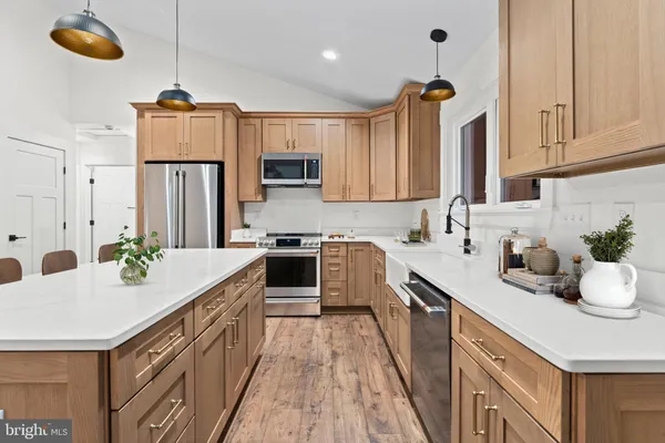a kitchen with stainless steel appliances a sink stove and refrigerator