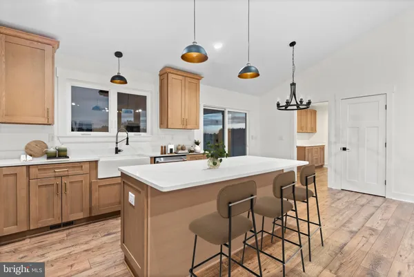 a kitchen with a table chairs sink and cabinets
