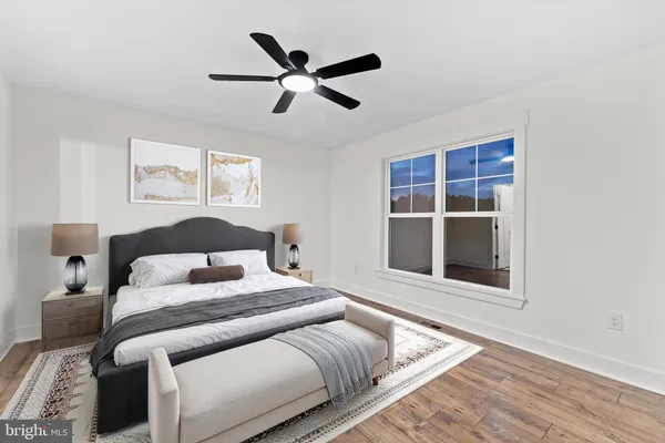 a bedroom with a large bed and a window