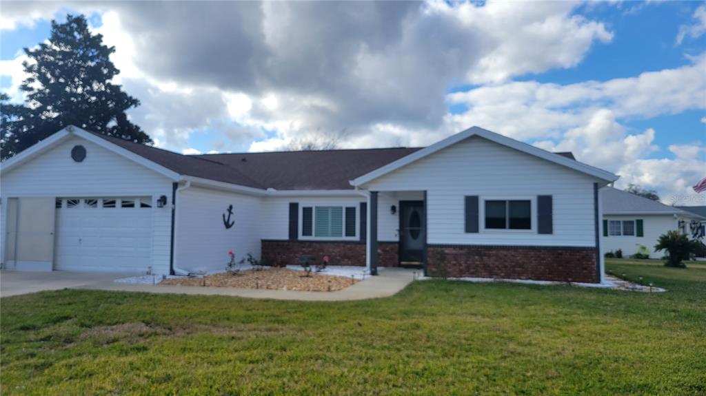 a front view of house with yard and outdoor seating