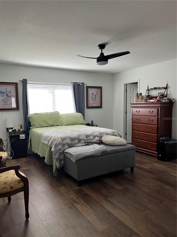 13834 Southwest 114th Avenue Dunnellon, FL 34432 - Photo 11 of 22 a bedroom with a bed and a chandelier