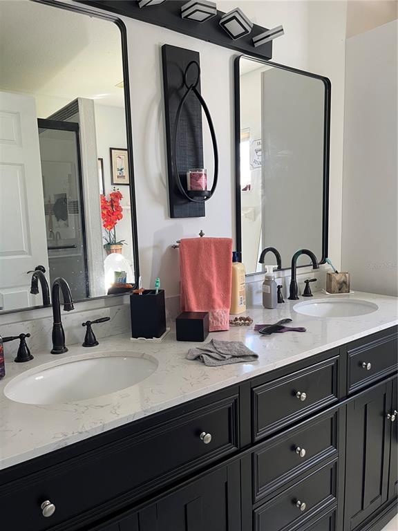 13834 Southwest 114th Avenue Dunnellon, FL 34432 - Photo 13 of 22 a bathroom with a double vanity sink and a mirror