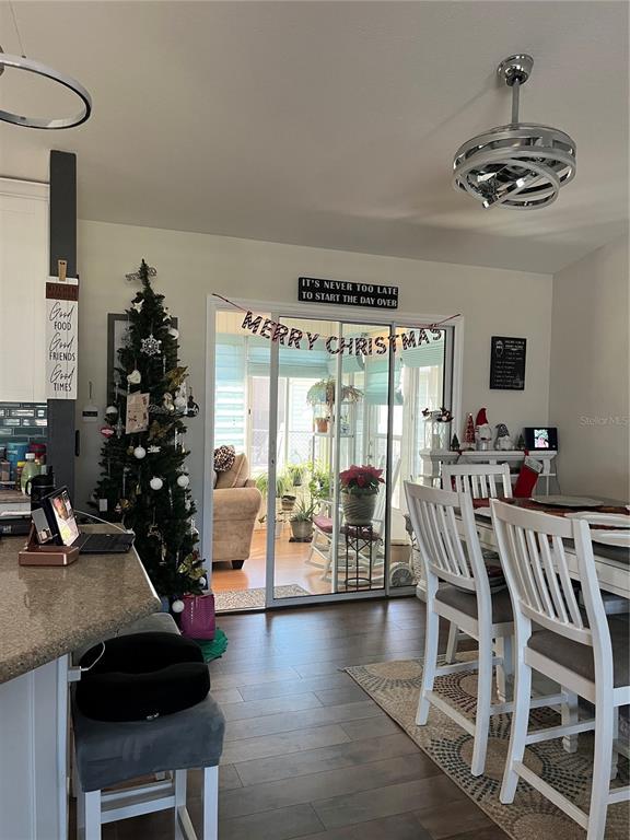 13834 Southwest 114th Avenue Dunnellon, FL 34432 - Photo 8 of 22 a view of a dining room with furniture wooden floor and chandelier
