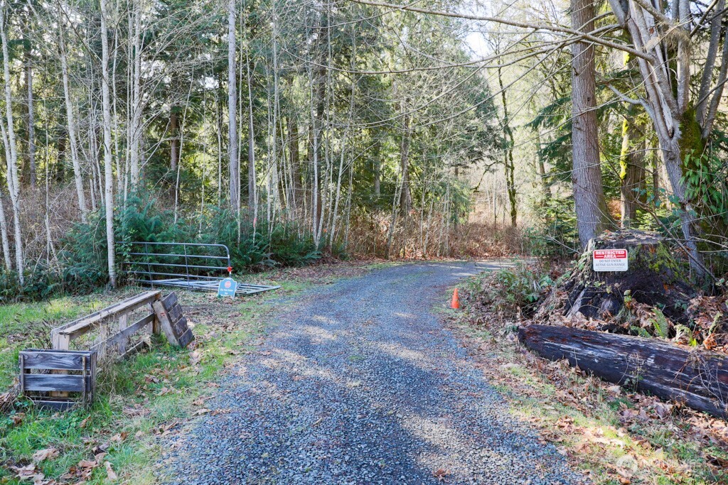 26663 Big Valley Road Northeast Poulsbo, WA 98370 - Photo 18 of 40 a backyard of a house with lots of green space