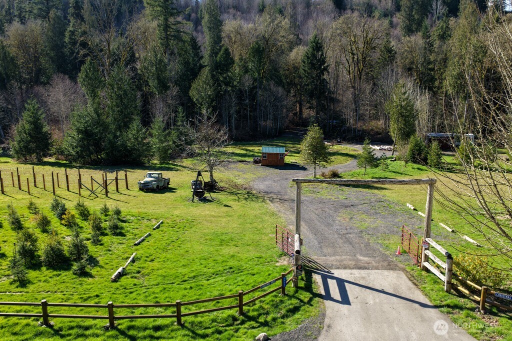 26663 Big Valley Road Northeast Poulsbo, WA 98370 - Photo 2 of 40 a view of a garden with a bench