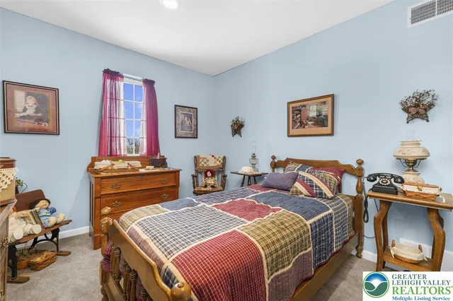 a bedroom with a bed and dresser