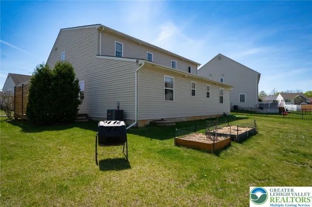 a backyard of a house with table and chairs
