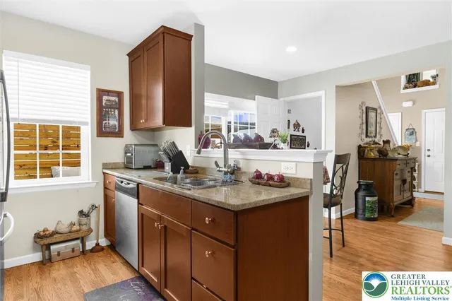 a kitchen with stainless steel appliances granite countertop a refrigerator stove and microwave