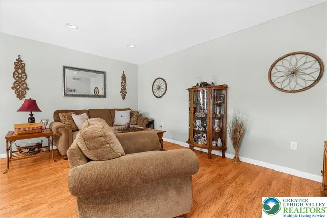 a living room with furniture a wooden floor and a fireplace