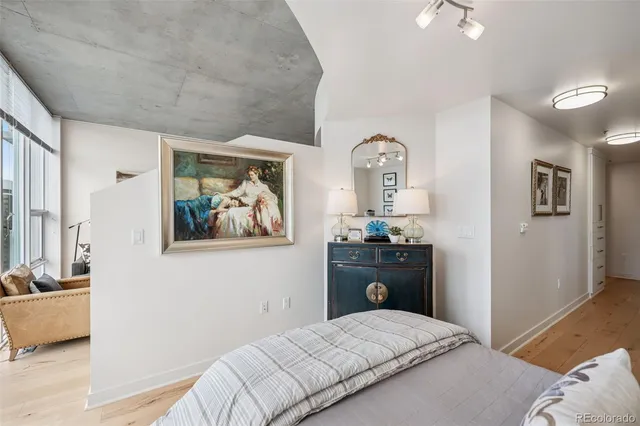 a view of a hallway with white walls and stairs