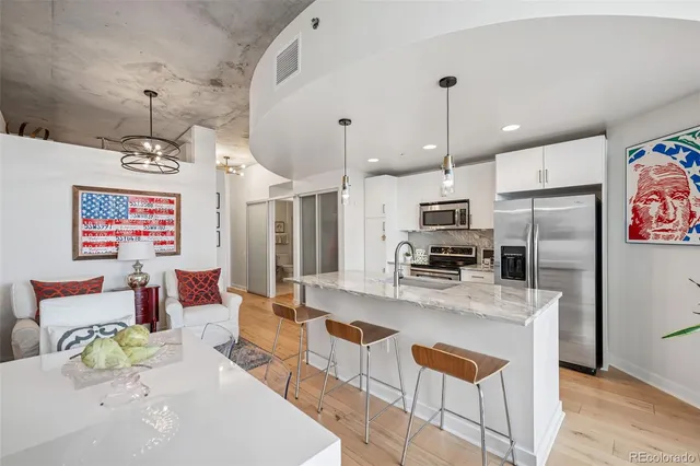 a large kitchen with a table and chairs