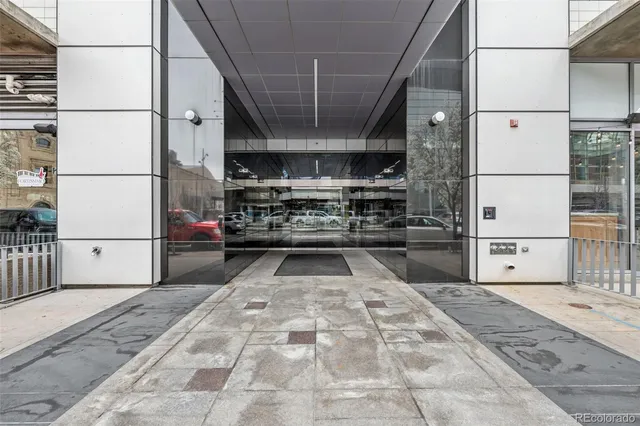 a living room with furniture a flat screen tv and kitchen view