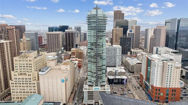 a living room with a couch and chandelier