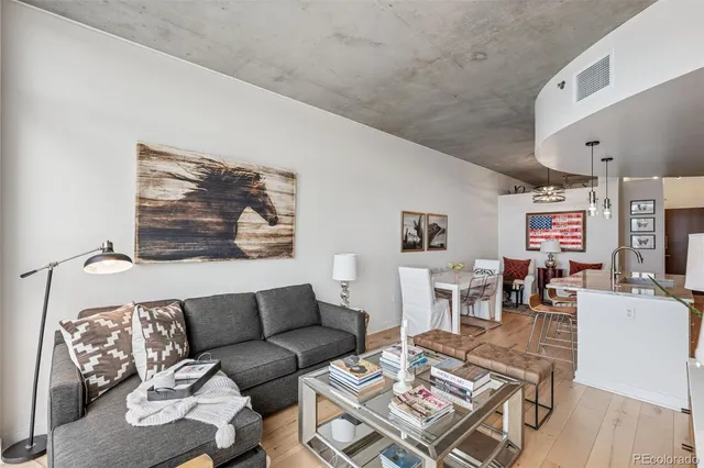 a living room with furniture and a floor to ceiling window