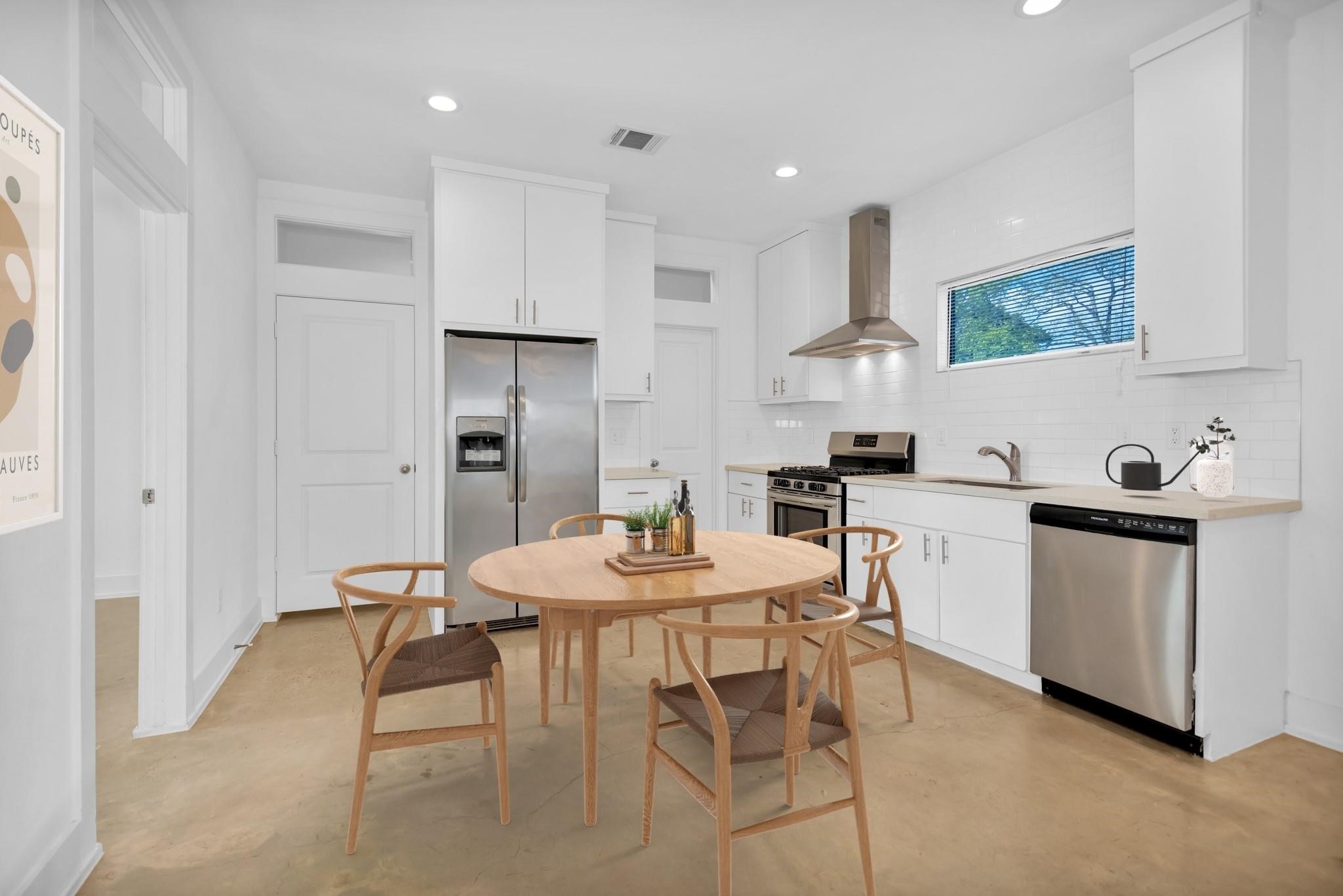 603 Edgewood Street, Unit B Houston, TX 77023 - Photo 5 of 16 a view of a dining room with furniture and wooden floor