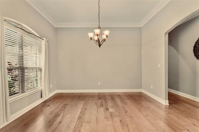 a view of a room with wooden floor closet and windows