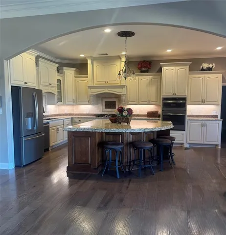 a large kitchen with cabinets table and chairs