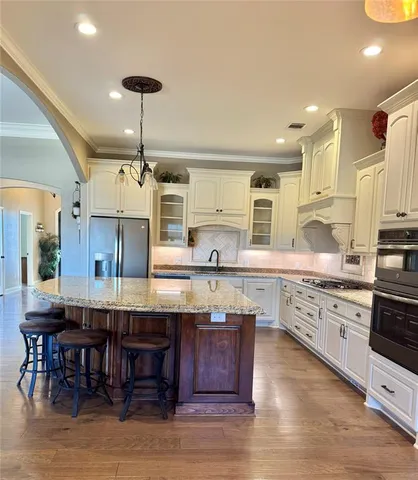 a kitchen with stainless steel appliances granite countertop a stove and refrigerator