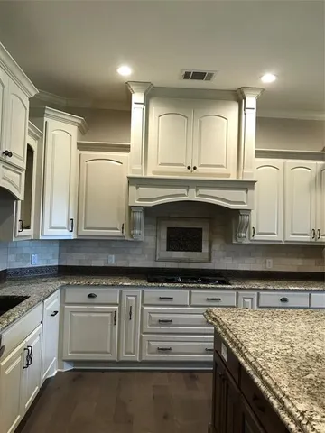 a kitchen with stainless steel appliances granite countertop a stove and a sink