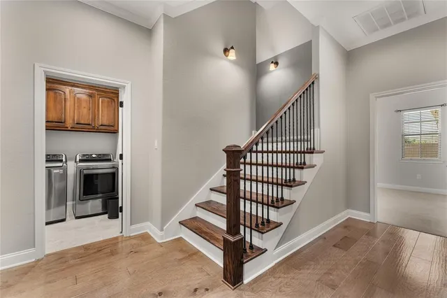 a spacious bedroom with a bed and a flat screen tv