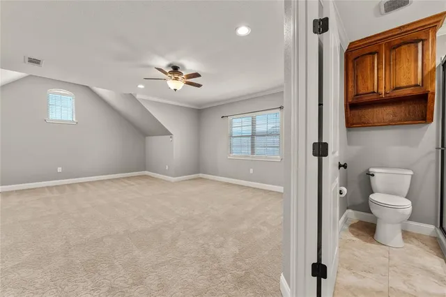 a bathroom with a granite countertop sink toilet and mirror