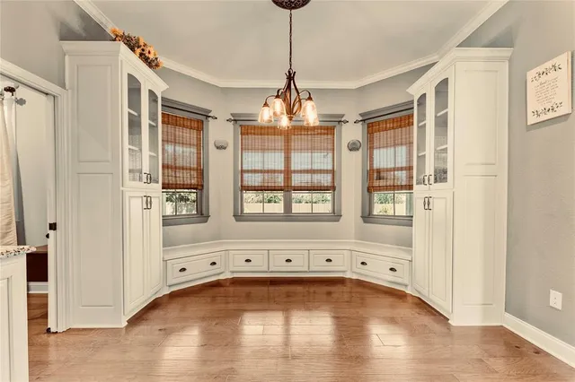 a view of a livingroom with wooden floor and windows