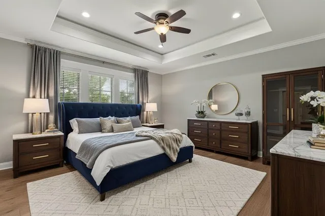 a bedroom with a large bed and a dresser