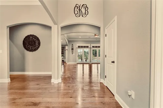 a view of a hallway with wooden floor