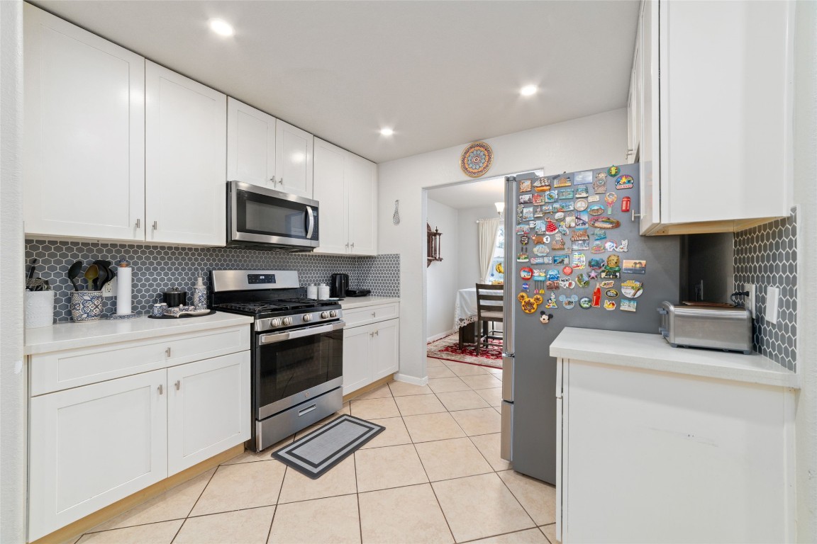 3038 Winchester Rnch Trail Katy, TX 77493 - Photo 11 of 29 a kitchen with stainless steel appliances a stove a sink a microwave a refrigerator and cabinets