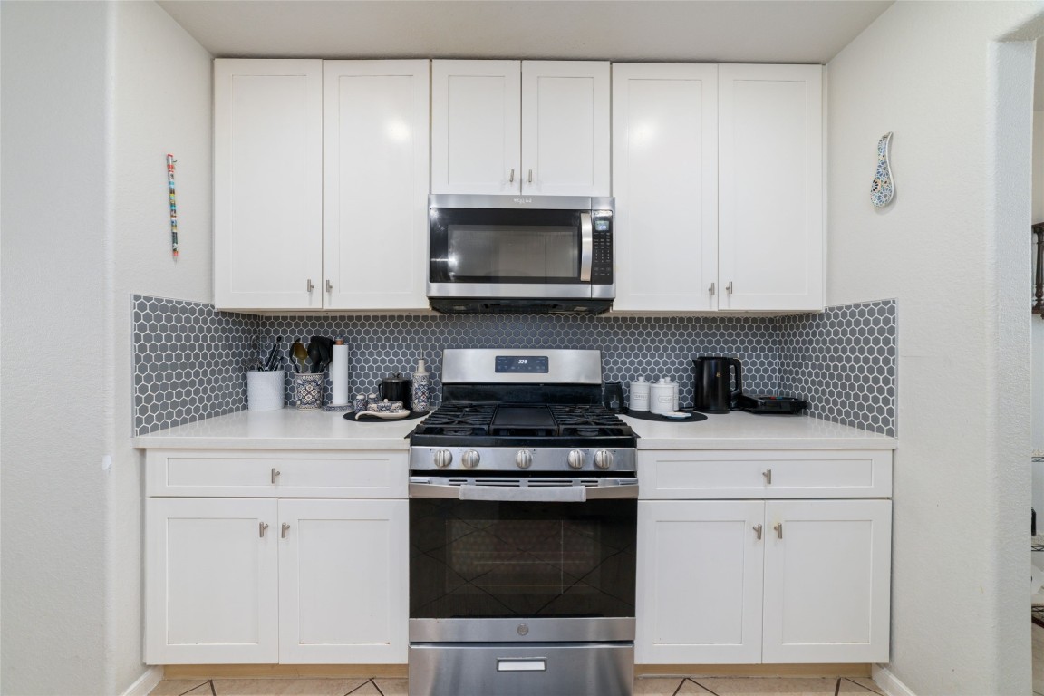 3038 Winchester Rnch Trail Katy, TX 77493 - Photo 13 of 29 a kitchen with stainless steel appliances granite countertop a stove a microwave and cabinets