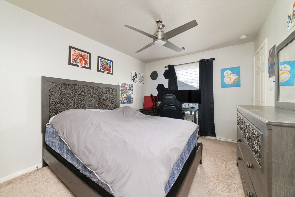 3038 Winchester Rnch Trail Katy, TX 77493 - Photo 16 of 29 a bedroom with a large bed and a chandelier