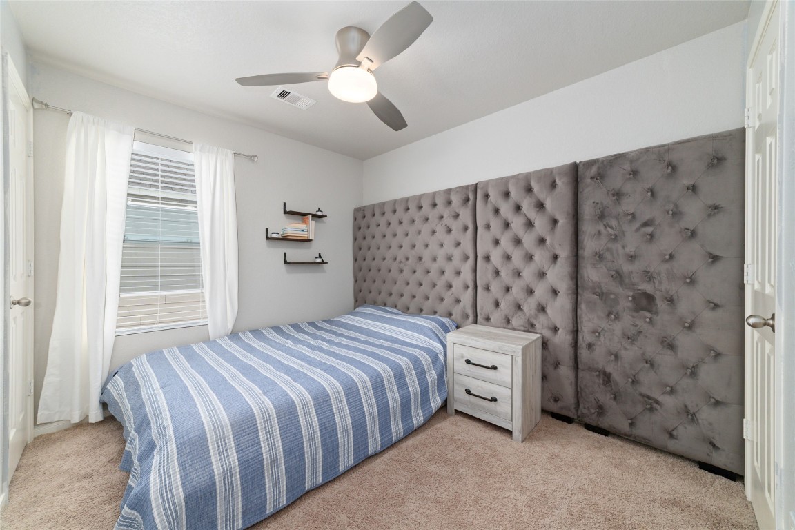 3038 Winchester Rnch Trail Katy, TX 77493 - Photo 19 of 29 a bedroom with a bed and a chandelier