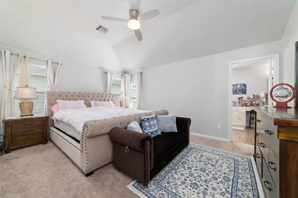 3038 Winchester Rnch Trail Katy, TX 77493 - Photo 20 of 29 a bedroom with a bed and a chandelier