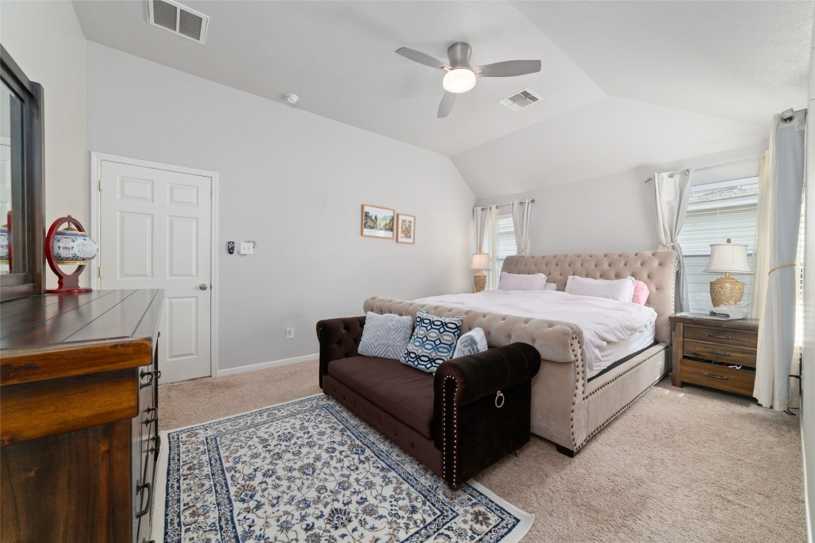 3038 Winchester Rnch Trail Katy, TX 77493 - Photo 21 of 29 a bedroom with a bed a dresser and potted plant