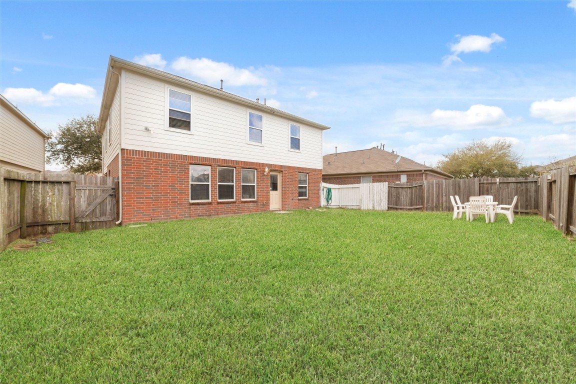 3038 Winchester Rnch Trail Katy, TX 77493 - Photo 28 of 29 a front view of a house with a garden and porch