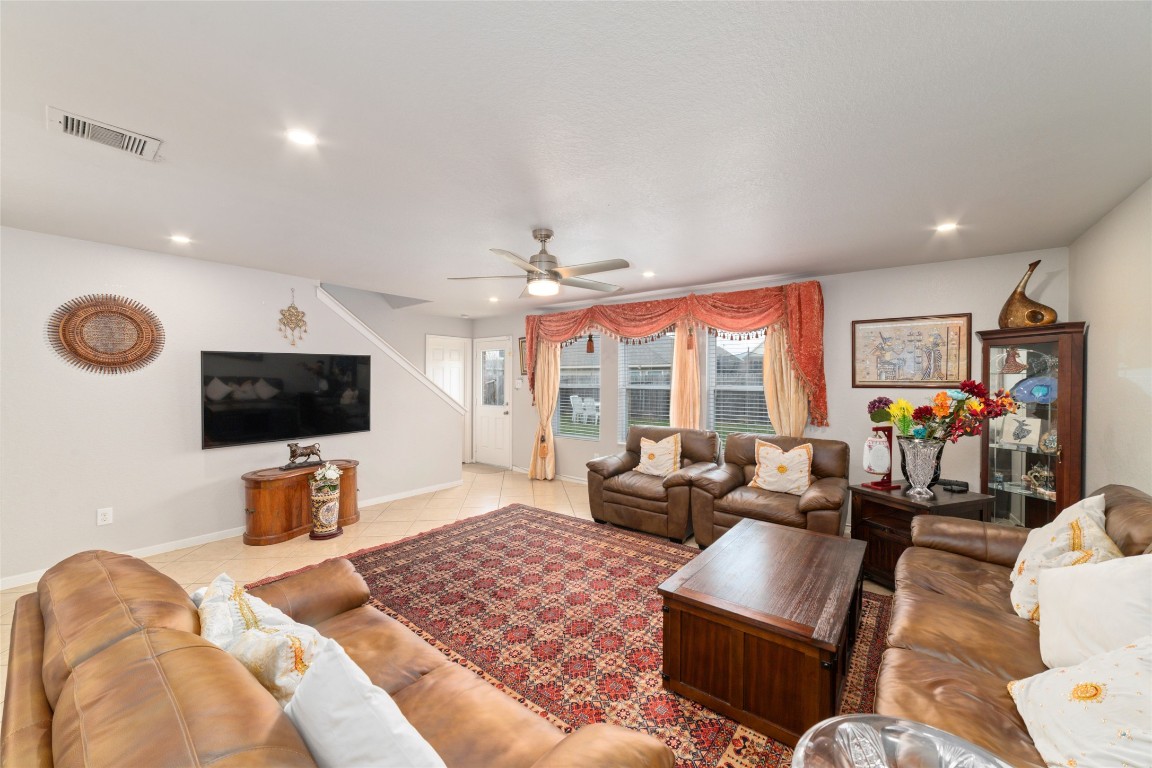 3038 Winchester Rnch Trail Katy, TX 77493 - Photo 5 of 29 a bedroom with furniture a flat screen tv and a floor to ceiling window
