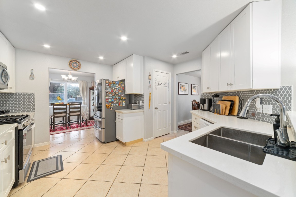 3038 Winchester Rnch Trail Katy, TX 77493 - Photo 10 of 29 a kitchen with a sink and a refrigerator