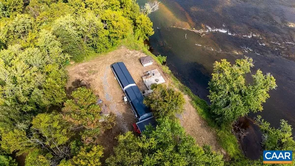 a wooden bench sitting in the middle of a yard