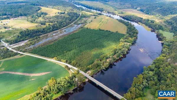 an aerial view of a golf course with a lake view
