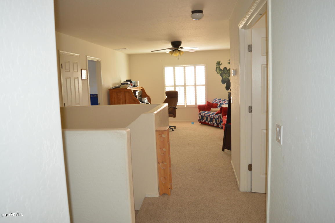 4351 East Pinto Valley Road San Tan Valley, AZ 85143 - Photo 13 of 27 a view of a hallway with furniture and a window