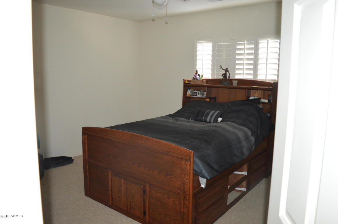 4351 East Pinto Valley Road San Tan Valley, AZ 85143 - Photo 19 of 27 a bedroom with a bed and a window