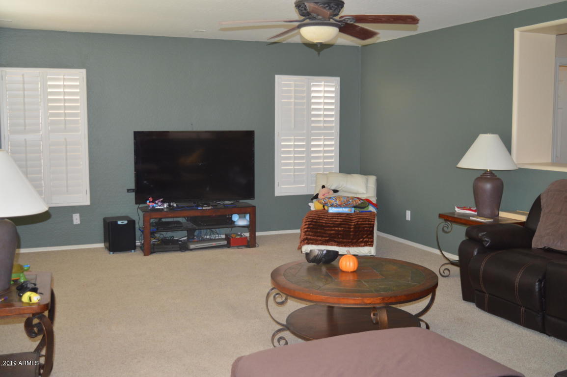 4351 East Pinto Valley Road San Tan Valley, AZ 85143 - Photo 6 of 27 a living room with furniture and a flat screen tv