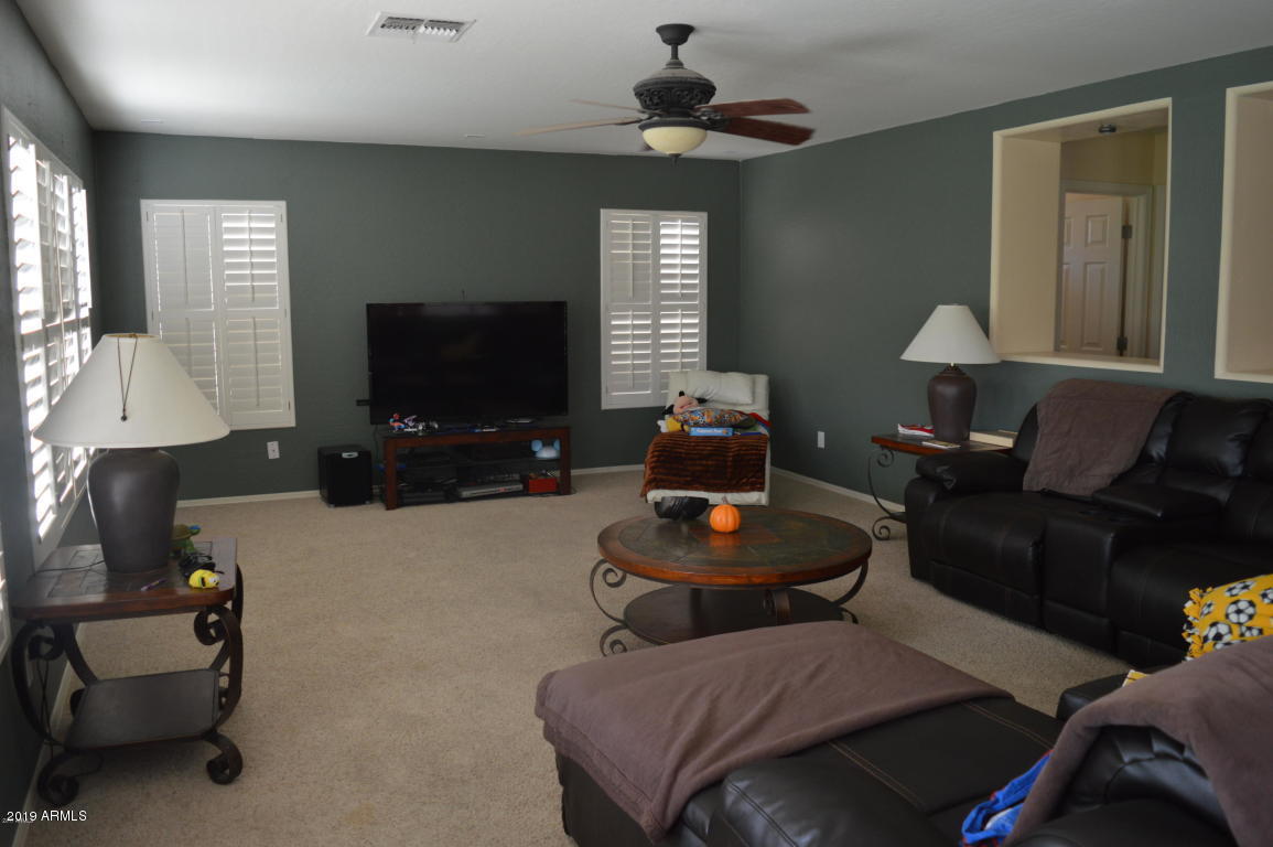 4351 East Pinto Valley Road San Tan Valley, AZ 85143 - Photo 7 of 27 a living room with furniture and a flat screen tv